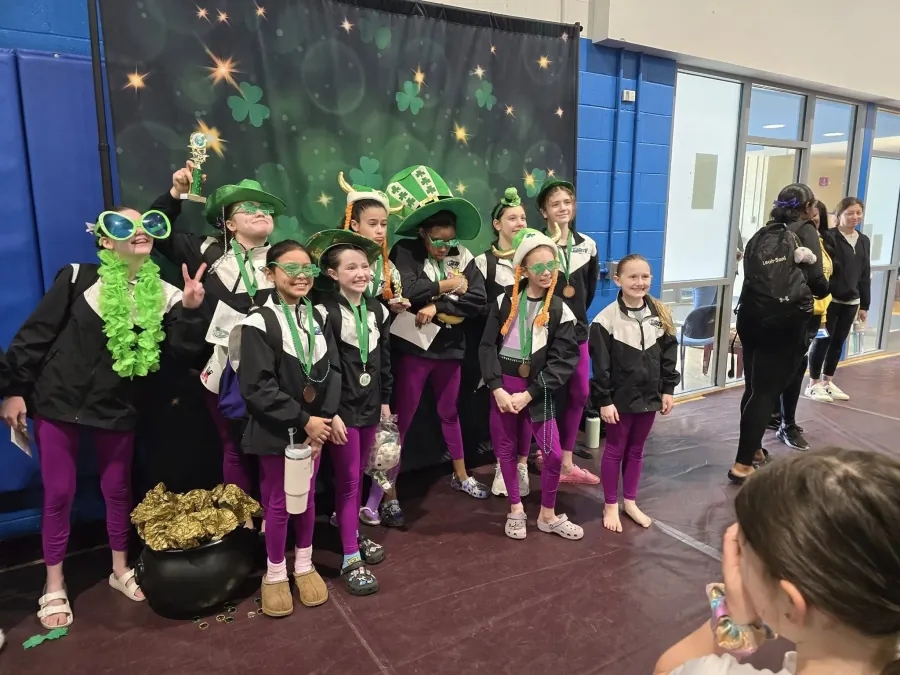 Galaxy Gymnastics team celebrating at a USA Gymnastics meet