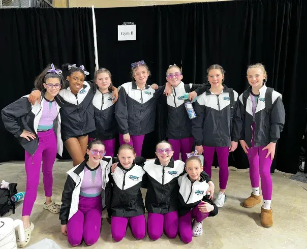 Galaxy Gymnastics teammates cheering at a meet in Salisbury, MD